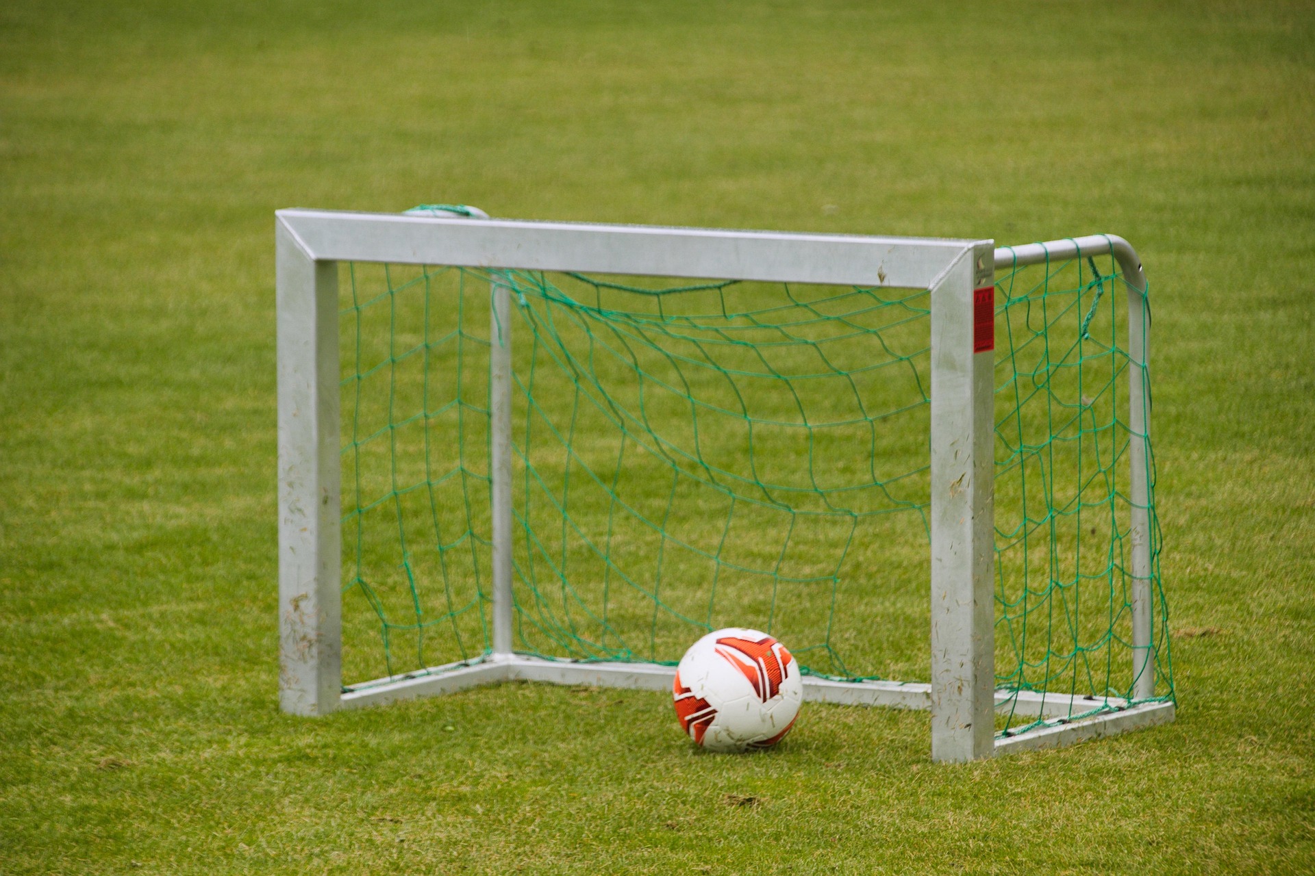 Soccer goal with a ball resting on the grass at Stepe Soccer Academy